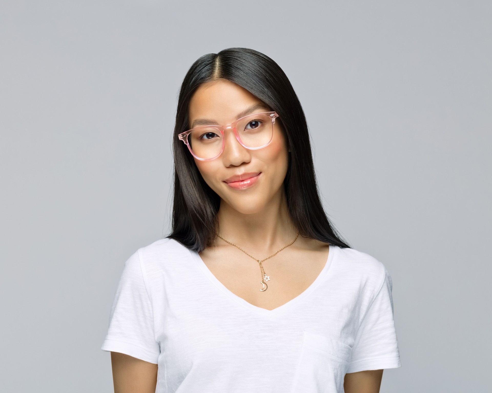 Woman wearing eyeglasses against gray background